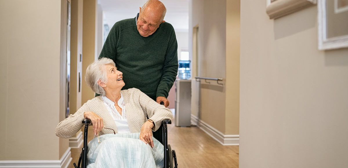 VRS Pacific Carlton senior man visiting disabled woman on wheelchair at nursing home
