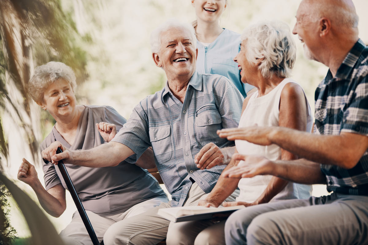 Seniors Sitting Outside Laughing at South Surrey White Rock VRS Retirement Community
