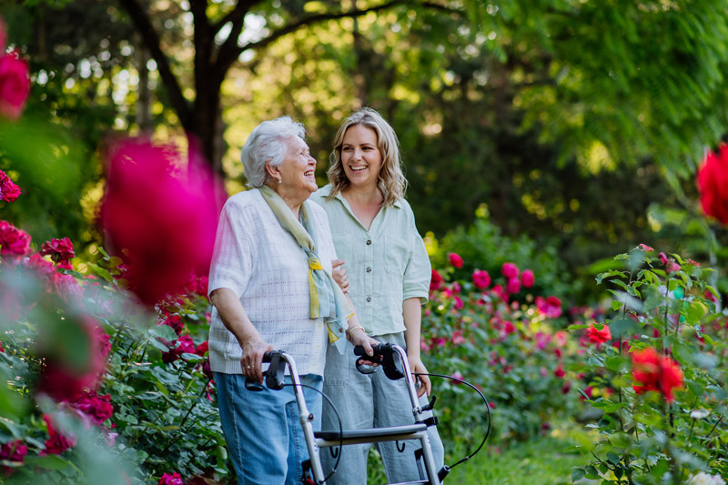 Senior safely walking outside with a walker at a senior independent or assisted living community in South Surrey White Rock
